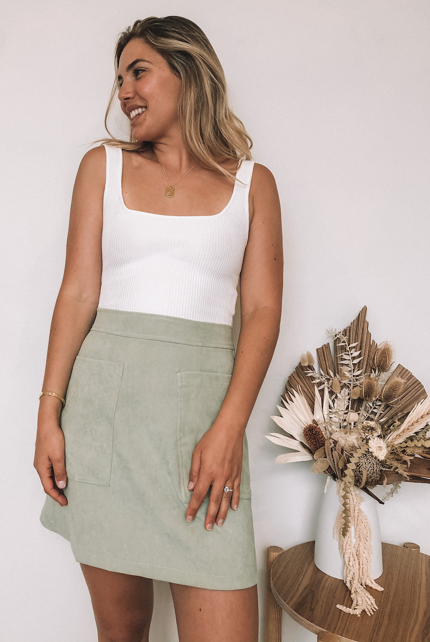 Women's sage fitted mini skirt with front pockets by Esther & Co