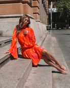 Model wearing the Daenerys Mini Dress in Orange Print showing full outfit styling