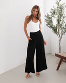 Women's black high waisted wide leg pants with belt loops and side pockets, the Alka Pants in Black by Esther & Co