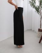 Women's black wide leg pants styled with a cami by Esther & Co
