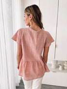 Arlo terracotta linen blouse styled with shorts