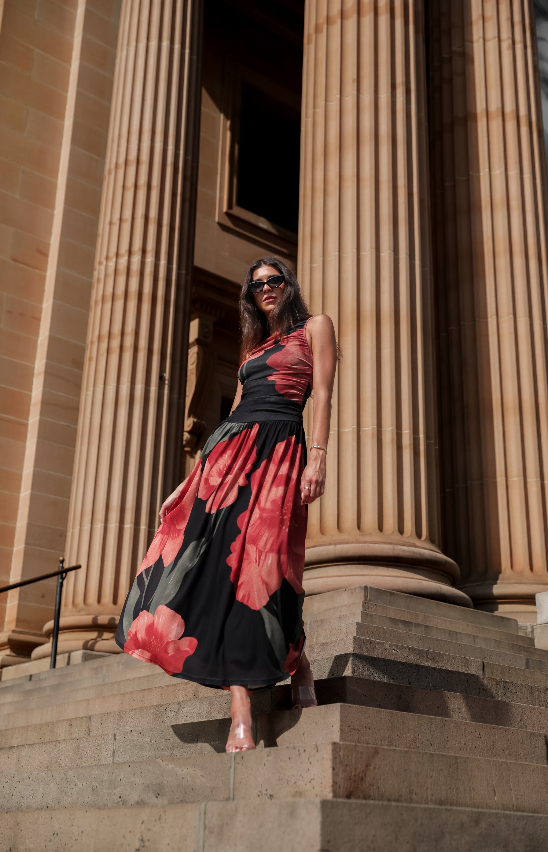 Women's black floral maxi dress with bold red floral print, boat neckline and flowy maxi skirt, the Balayage Dress in Black Floral by Esther & Co