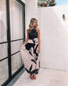 Women's flowy mono floral print midi dress styled for evening by Esther & Co
