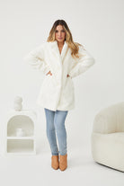 Side view of the Bernie Jacket in Ivory showing the longline fit and long sleeves