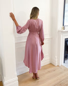 Model wearing the Bryleigh Blush Formal Dress styled with strappy heeled sandals for a wedding look