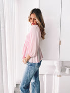 Women's feminine pink blouse with bubble sleeves and flowy peplum silhouette by Esther & Co