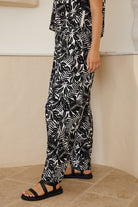 Women's printed wide-leg trousers styled with a collared top by Esther & Co