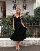 Front view of the Celie Black Linen Midi Dress showing the V-neckline and frill detail
