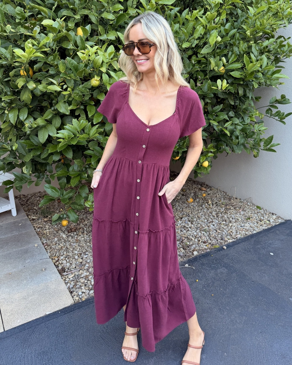 Side view of the Celie Dress in Bordeaux showing the midi length and button-up detail