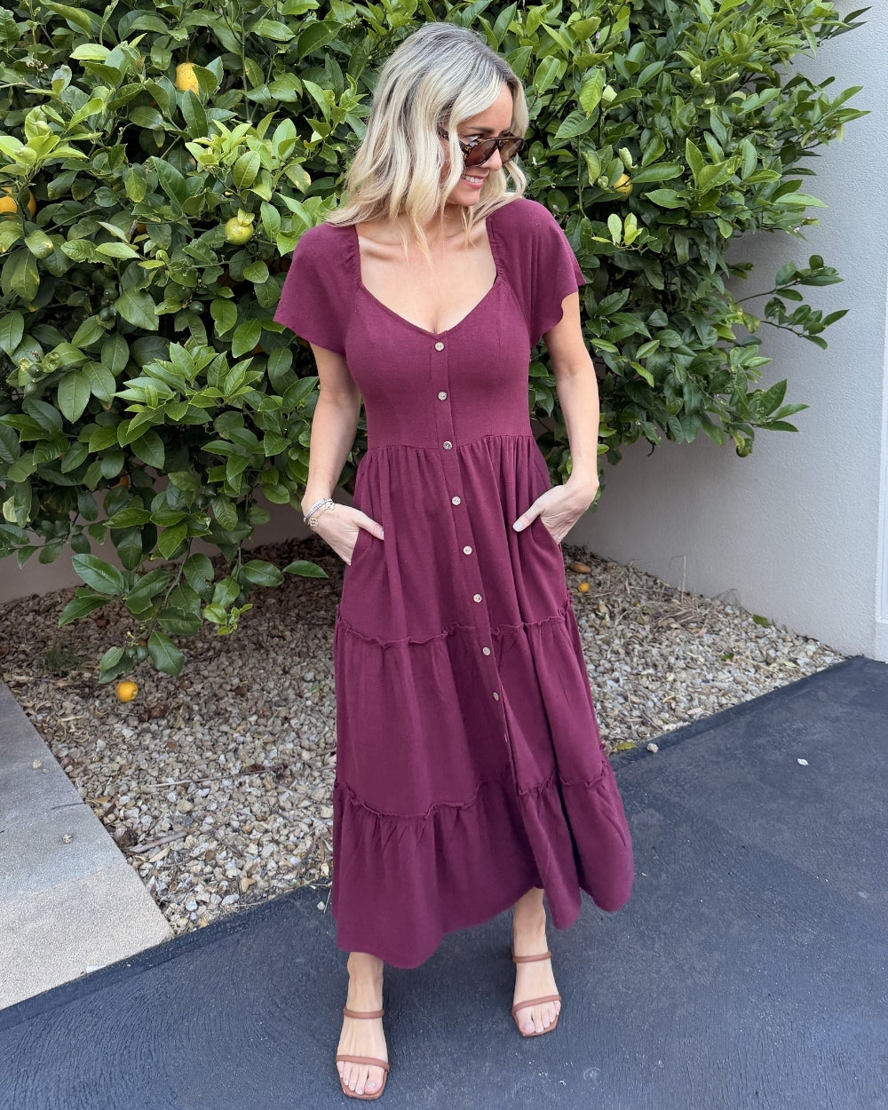 Women wearing the Celie Dress in Bordeaux, a relaxed linen midi dress with V-neckline and button-up front