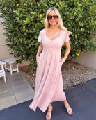 Front view of the Celie Pink Linen Midi Dress showing the V-neckline and flowing A-line silhouette