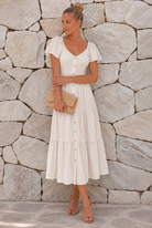 Celie Dress in Beige, a women's beige linen midi dress with V neckline and tiered frill skirt by Esther & Co