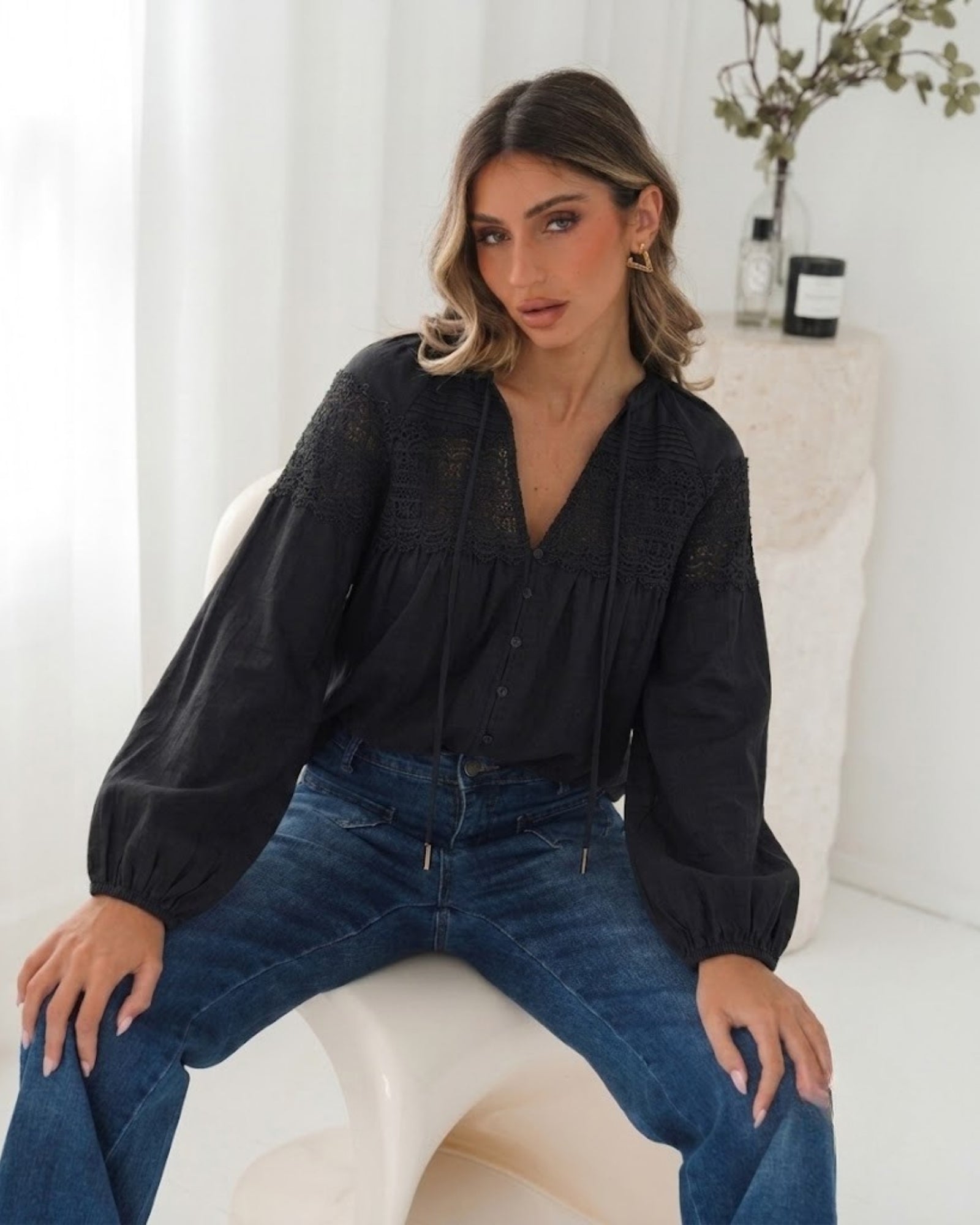 Women's black lace blouse with V neckline and balloon sleeves, the Chenille Blouse in Black Lace by Esther & Co