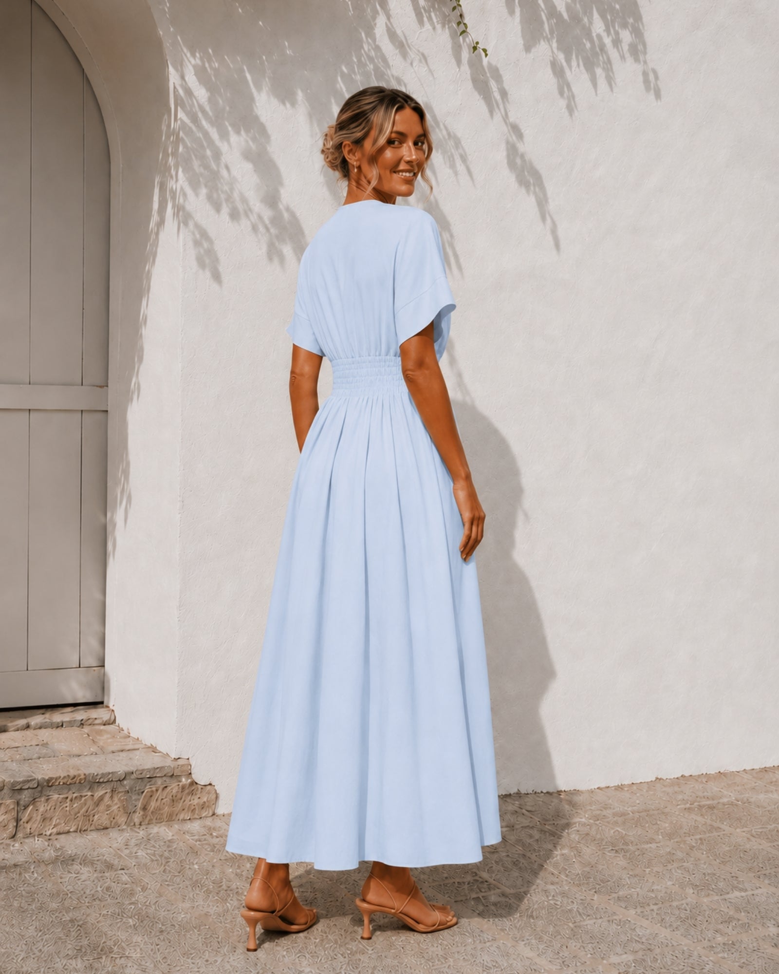 Women's blue pleated maxi dress with structured waist panel, the Clairice Dress in Blue by Esther & Co