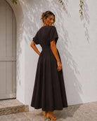 Women's chocolate brown pleated maxi dress with gold statement buttons, the Clairice Dress in Choco by Esther & Co