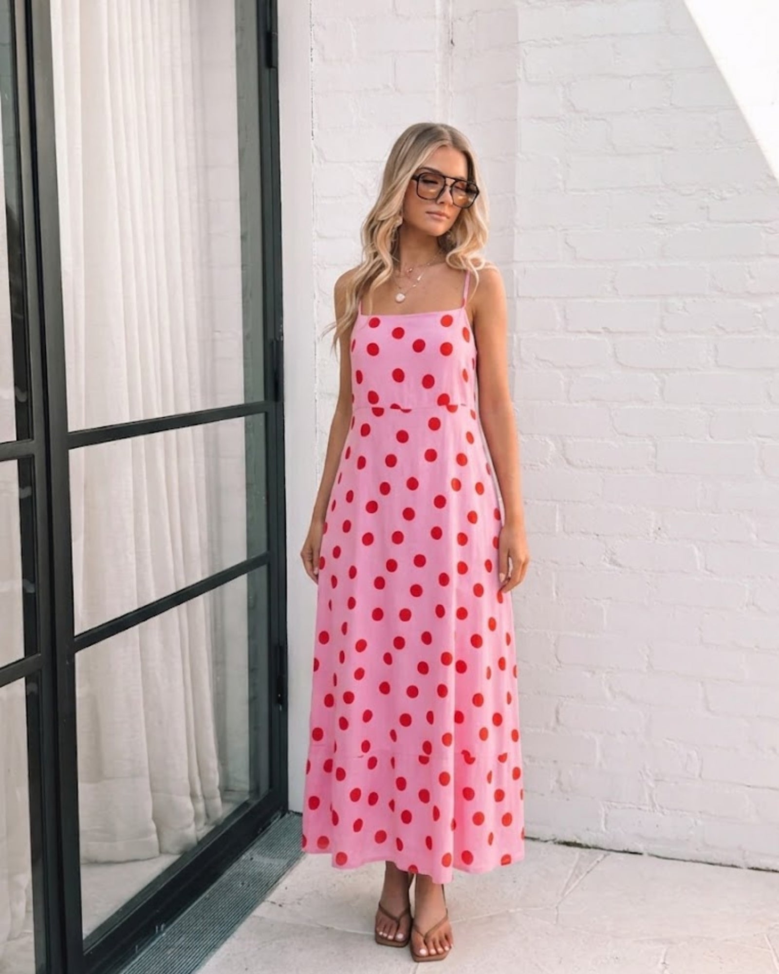 Women's pink polka dot midi dress styled outfit by Esther & Co