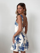 Women's white blue floral print mini dress styled for an event by Esther & Co
