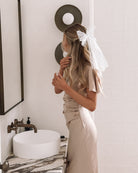 Doren champagne satin maxi dress with V-neckline, side view