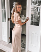 Front view of the Doren Champagne Satin Maxi Dress showing the V-neckline and flowing draped silhouette