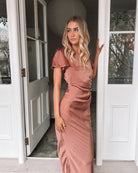 Front view of the Doren Rust Satin Maxi Dress showing the V-neckline and flowing draped silhouette