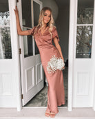 Women wearing the Doren Dress in Rust, a formal satin maxi dress with V-neckline from the Esther Luxe Collection