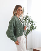 Side view of the Dorine Forest Green Knit Cardigan showing the open front and long sleeve detail