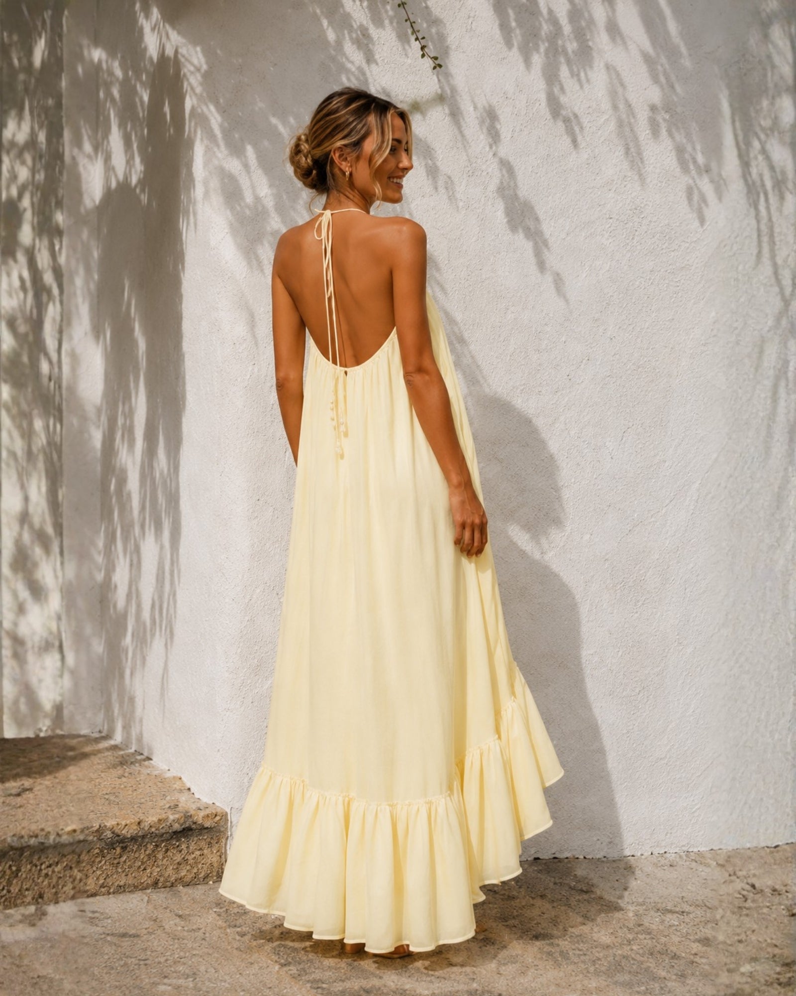 Women's pastel yellow halter neck high low maxi dress, the Flynne Dress in Sunrise Glow by Esther & Co