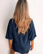 Fraise navy linen blouse with V neckline and button front, styled view