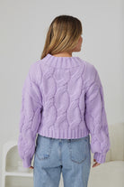 Model wearing the Hadi Lilac Knit Jumper tucked into a midi skirt with boots for an elevated winter look