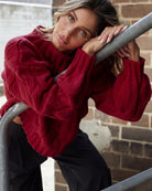 Front view of the Hadi Wine Knit showing the high round neckline and relaxed textured knit