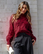Women wearing the Hadi Knit in Wine, a cosy acrylic women's jumper with high round neckline and long sleeves