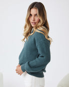 Side view of the Harvie Knit in Petrol showing the longline silhouette and cosy wool blend fabric