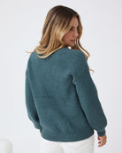 Model wearing the Harvie Petrol Knit Jumper with straight leg jeans and ankle boots for a casual street style look