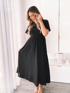 Front view of the Iolana Black Midi Dress showing the A-line silhouette and smocked bodice
