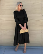 Front view of the Iolana Black Long Sleeve Midi Dress showing the round neckline and textured A-line fit