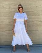 Side view of the Iolana White Midi Dress showing the flowing A-line cotton skirt