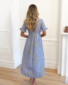 Side view of the Korbel Dress in Blue Stripe showing the midi length and relaxed flowing silhouette