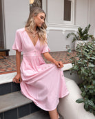 Korbela Dress in Powder Pink powder pink linen midi dress with V-neckline and button-up front side view