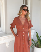 Korbela Dress in Rust womens rust linen midi dress back view
