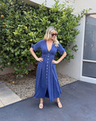 Model wearing the Korbela Navy Midi Dress styled with white sneakers for a casual everyday look