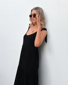 Lydia black tiered linen midi dress, side view