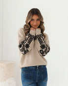Womens latte wool blend jumper with contrast floral embroidery, styled view
