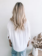 Plato white linen blouse with twist hem, detail view