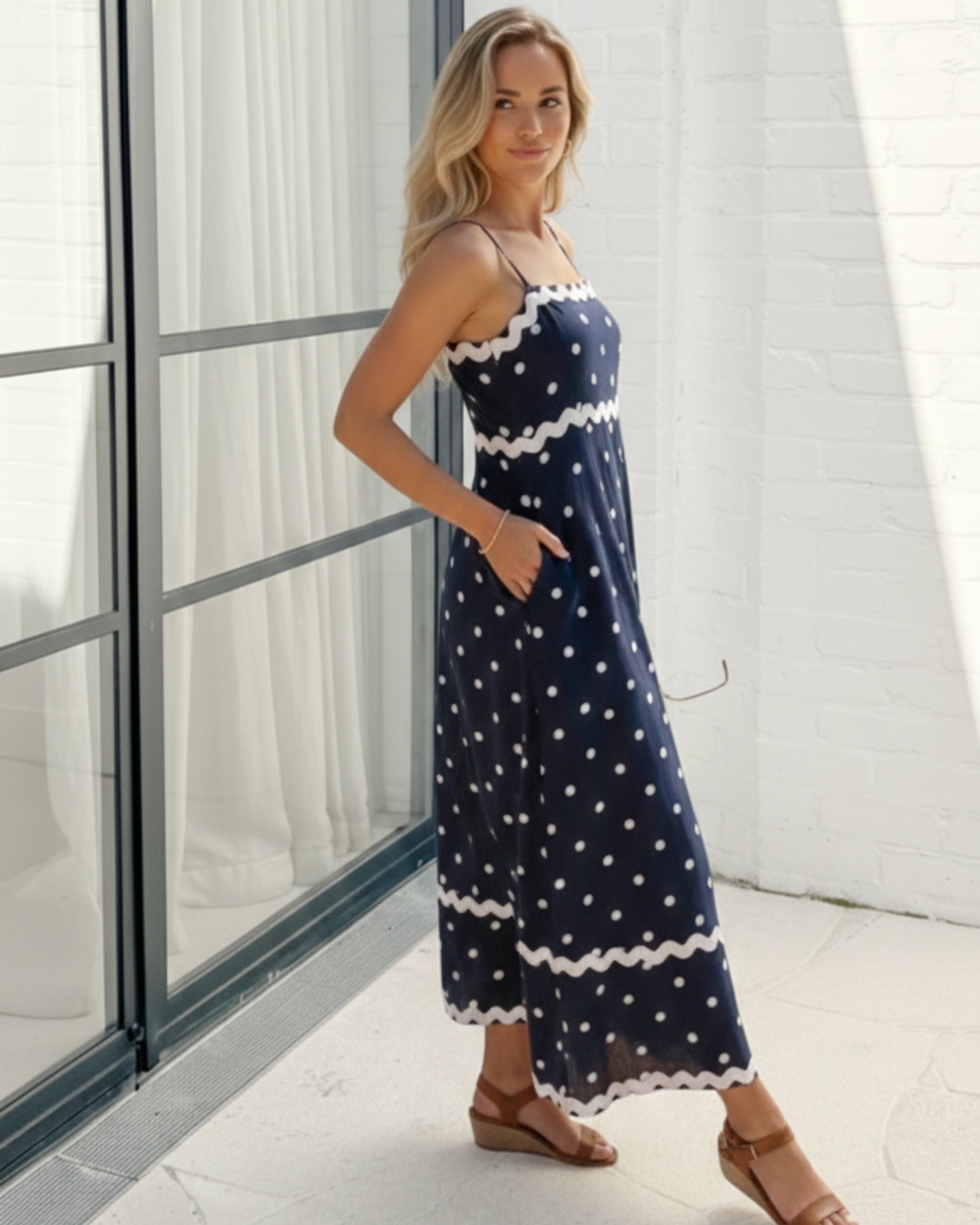 Women's navy polka dot midi dress side view by Esther & Co