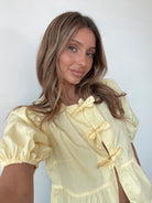 Women's yellow puff sleeve peplum top by Esther & Co