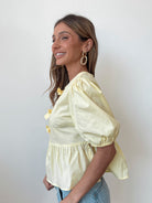 Women's yellow peplum top with round neckline by Esther & Co
