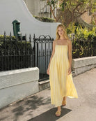 Women's yellow stripe maxi dress with adjustable straps by Esther & Co