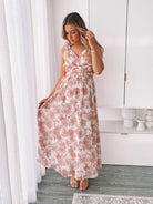 Women's white and peach floral maxi dress with frilled straps and side cutouts, the Shanta Dress in Peach Floral by Esther & Co