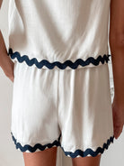 Women's white high waisted shorts styled with a top by Esther & Co