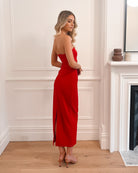 Elegant woman in a red strapless evening gown, perfect for weddings, formal events, balls, galas, and special occasions, standing in a sophisticated room with wooden flooring and a fireplace.